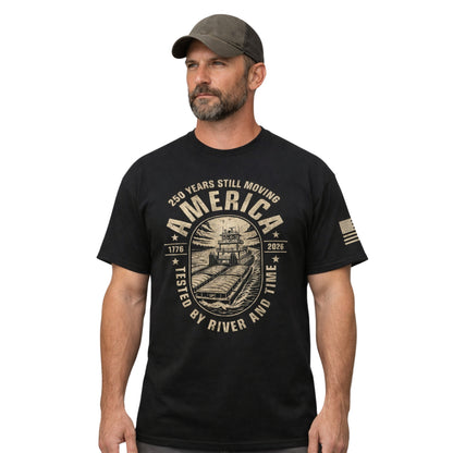Man wearing a black t-shirt with a graphic design and text, standing against a white background 250 years still moving america towboater